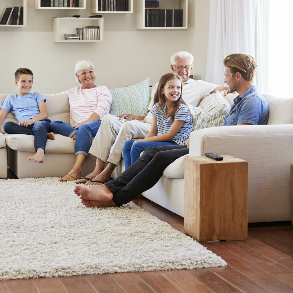 Happy family sitting on flooring | Chesapeake Family Flooring